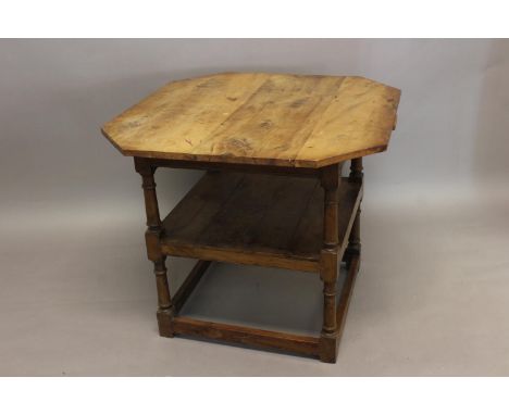 AN 18TH CENTURY STYLE YEW WOOD 'MONKS' TABLE. With a rectangular top with canted corners, on turned uprights with under shelf