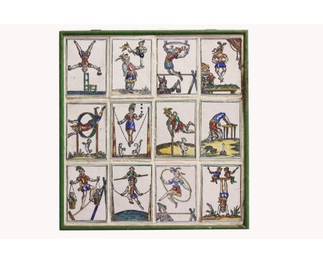 A FRAMED PANEL OF 12 CERAMIC TILES OF PERFORMING ACROBATS. The twelve tin glazed tiles of performing acrobats attempting vari