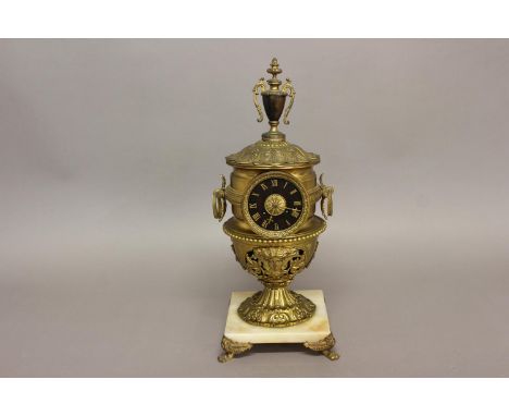 AN ELABORATE URN SHAPED MANTEL CLOCK. The clock with a black dial with gilt Roman numerals, with an eight day two train movem