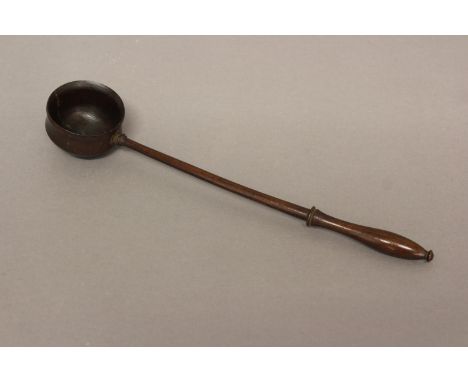 AN EARLY 19TH CENTURY TREEN PUNCH LADLE. With a slender handle with shaped end and straight shaft with bowl shaped body, 30cm