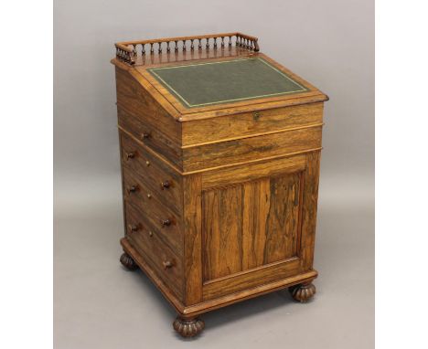 A GEORGE IV ROSEWOOD DAVENPORT. With a sloping leather lined writing surface and galleried top, enclosing an interior with a 