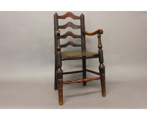 AN EARLY 18TH CENTURY LADDER BACK CHILD'S CHAIR. With tapering uprights with four graduated arch topped ladders, with downswe