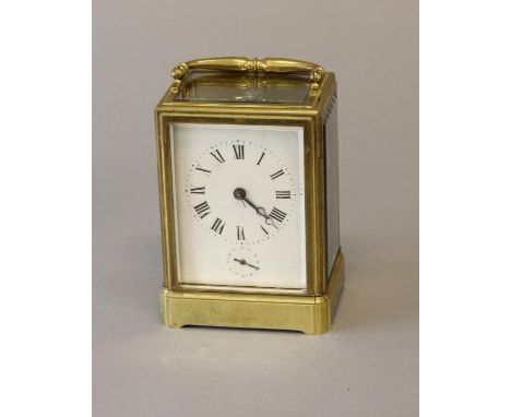 A BRASS CASED CARRIAGE CLOCK BY MOTTU OF PARIS. With a silvered rectangular dial with Roman numerals and subsidiary alarm dia
