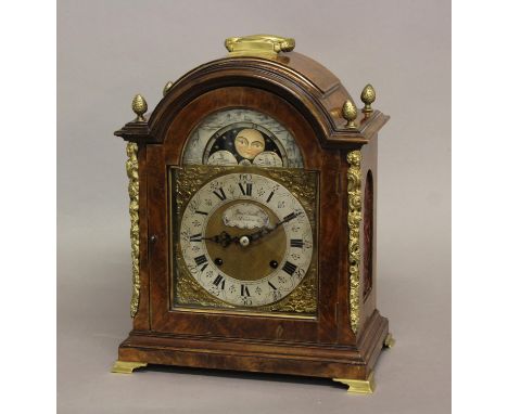 A GEORGE II STYLE WALNUT CASED BRACKET CLOCK. The arched dial with moon phase above a silvered chapter ring with Roman numera