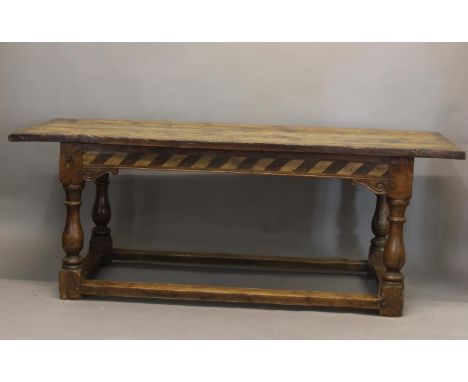 A 17TH CENTURY STYLE YEW WOOD DINING TABLE. With a broad three plank top with shaped end rails, on a frieze with sloping geom