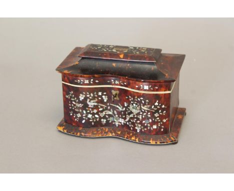 A REGENCY TORTOISESHELL VENEERED TEA CADDY. Of rectangular form with double bowed front and raised lid with central rectangul