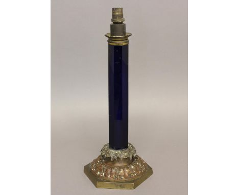 A VICTORIAN TABLE LAMP BASE WITH BLUE GLASS COLUMN. The octagonal 'Bristol' blue glass column on an hexagonal foliate cast ba