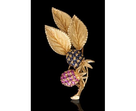 A 1960s ruby and sapphire berry brooch, being a naturalistic high carat yellow metal representation of a sprig with two berri
