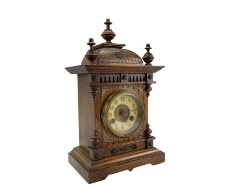 A late 19th Century German oak mantel clock, having a Junghans two-train movement striking on a coiled gong, its case of arch