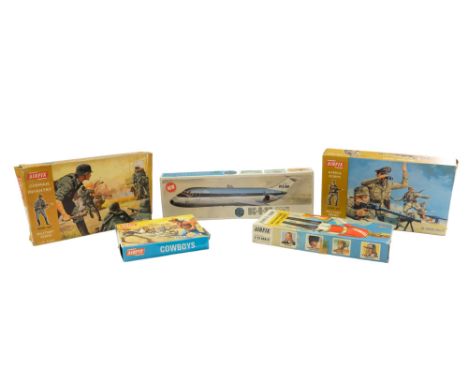 A group of vintage Airfix model kits comprising a McDonnell DC-9-30 aeroplane, Afrika Korps and German Infantry from the Mili