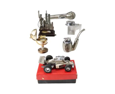 A novelty F1 car table cigarette lighter together with a microphone, New York, globe, pipe and Art Deco style lighters, car 1