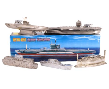 A boxed novelty U518-ART submarine table cigarette lighter together with five similar table lighters, aircraft carrier 28 cm