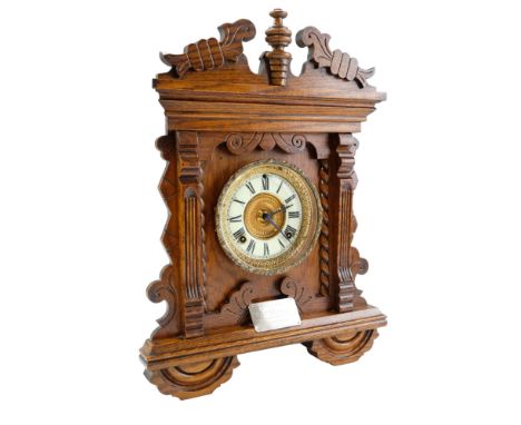 A late 19th Century carved oak mantel / shelf clock by The Ansonia Clock Company, having a spring-driven two-train movement s