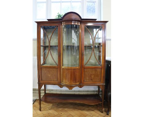 A Sheraton Revival period glazed and marquetry-inlaid mahogany display cabinet, of break bow front form, late 19th / early 20