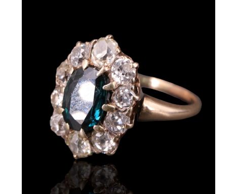 An Edwardian sapphire and diamond dress ring, having an oval sapphire of approximately 1.5 carats surrounded by 10 Old cut di