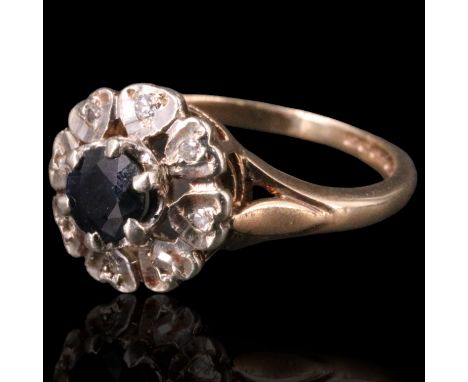 A sapphire and diamond ring, comprising a round-cut sapphire of approx 0.33 cts framed by small diamonds illusion set on radi