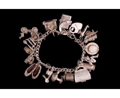 A vintage white metal charm bracelet, 64 g