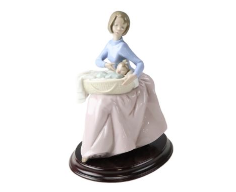 A boxed Nao "Bundle of Love" figurine on wooden base, dated 1994, 29 cm