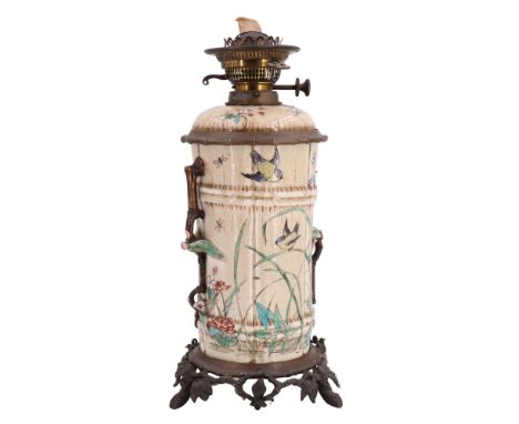 A Victorian Chinoiserie porcelain oil lamp, the reservoir and columnar stand in the form of bamboo, enamelled in depiction of