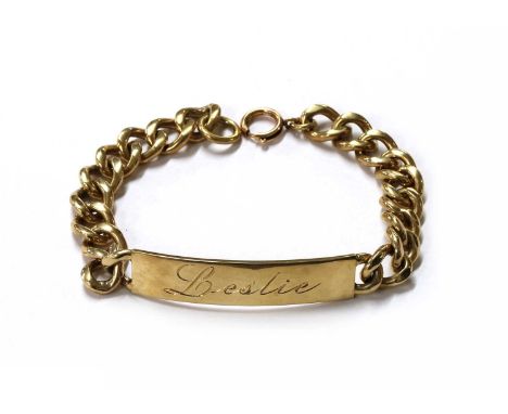 A 9ct gold identity bracelet, with a curved plaque engraved 'Leslie' to curb link chain and later bolt ring clasp, London 196