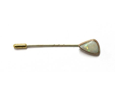 A gold opal stick pin, with a freeform opal, approximately 13.5 x 9.0mm, rub set, to pin, tested as approximately 9ct gold, 1