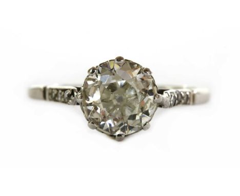 A platinum single stone diamond ring, with an old brilliant cut diamond, estimated as approximately 0.95ct, claw set to a scr