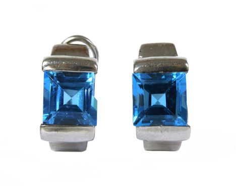 A pair of white gold blue topaz earrings, with a square step cut blue topaz, end set, to post and hinged omega fittings, test