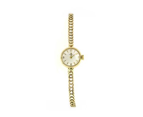 A ladies' 9ct gold Tissot mechanical bracelet watch, with a circular silvered dial, raised gilt batons and hands to integral 