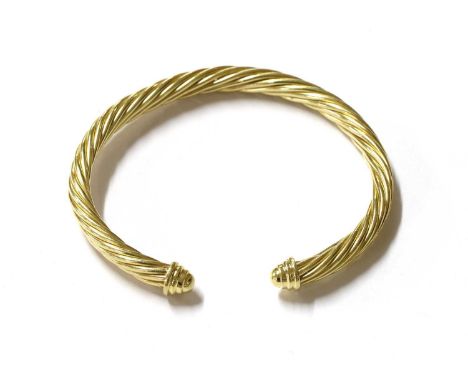 A gold cable torque bangle, by David Yurman, marked D. Yurman, 14k, tested as approximately 14ct gold, internal dimensions ap
