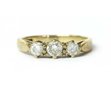 A 9ct gold three stone diamond ring, with a row of graduated brilliant cut diamonds, claw set, to open shoulders and a plain 