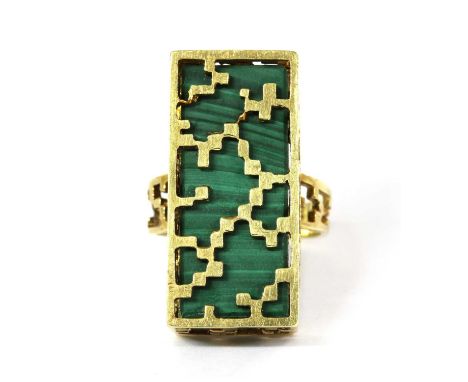 A gold malachite ring, with a rectangular malachite block with a pierced gold cage, to pierced shoulders and a plain shank, t