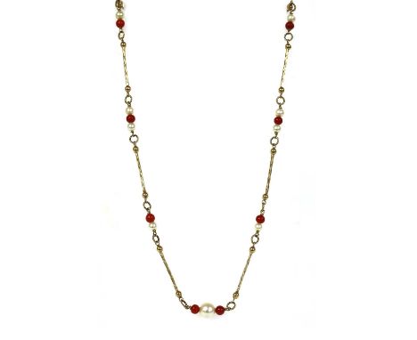 A gold cultured pearl and coral bead necklace, with cultured freshwater pearls and coral beads, on wire, joined by twisted wi