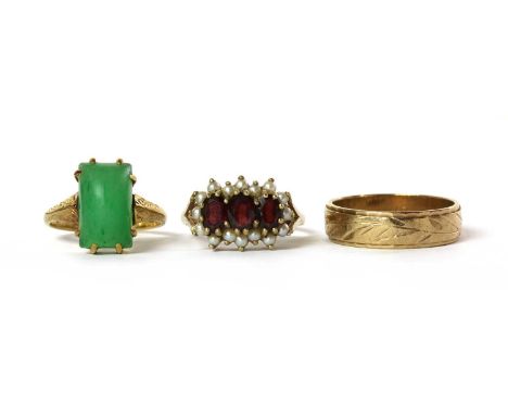 Three gold rings, to include a 9ct gold patterned wedding ring, London 1971, a 9ct gold garnet and split pearl cluster ring, 