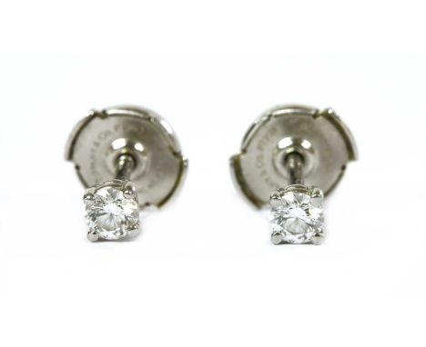 A pair of platinum single stone diamond earrings, by Tiffany &amp; Co., with a brilliant cut diamond, four claw set to post a