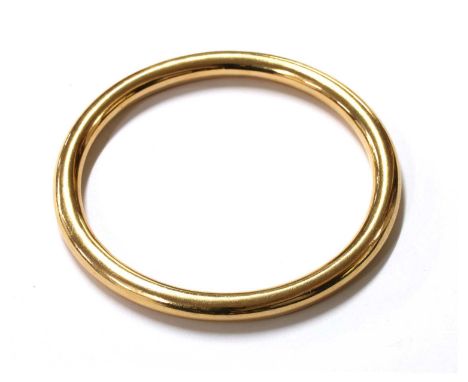 A gold hollow bangle, marked 15ct, approximately 77mm internal diameter, 25.92gCondition report: Minor surface marks, scratch
