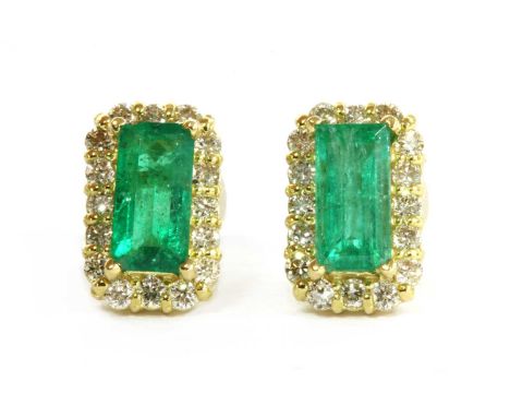 A pair of gold emerald and diamond cluster earrings, with a rectangular step cut emerald, approximately 6 x 3mm, claw set, to