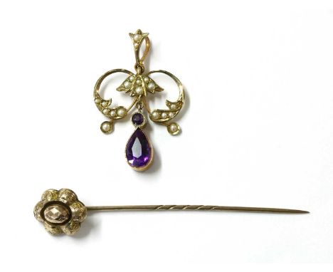 An Edwardian gold amethyst and split pearl pendant, a scrolling frame grain set with split pearls, suspending a pear and roun