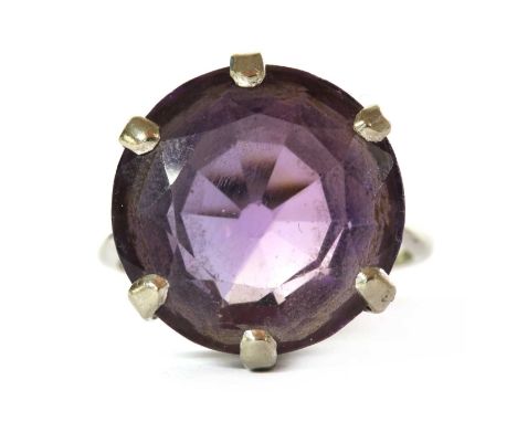 A white gold single stone amethyst ring, with a round mixed cut amethyst, approximately 16mm, claw set to solid tapered shoul