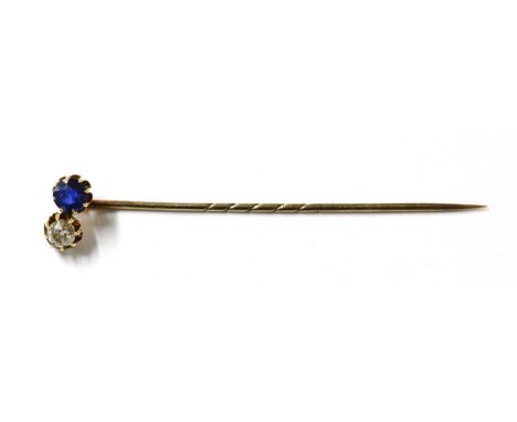 A gold sapphire and diamond stick pin, with an old cut diamond and a mixed cut sapphire, claw set, to gold pin, tested as app