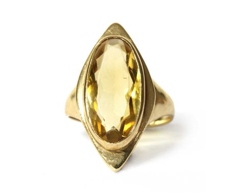 A 9ct gold single stone citrine ring, with an oval mixed cut citrine, rub set to a navette shaped head, to tapered shoulders 