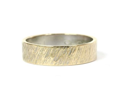 An 18ct white gold flat section wedding ring, with textured pattern, London 1971, 5mm wide, 3.82g.Finger size M-N approximate