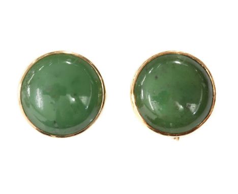 A pair of nephrite jade earrings, with a circular jade cabochon, rub set to a plain back plate, with later screw fittings, fi