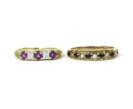 A 9ct gold amethyst and diamond ring, with alternating round mixed cut amethysts and pairs of eight cut diamonds, to a scroll