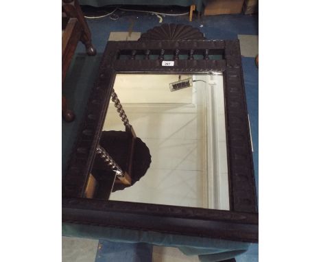 An Ebonised Carved Framed Wall Hanging Mirror with Base Shelf, 75cm high 