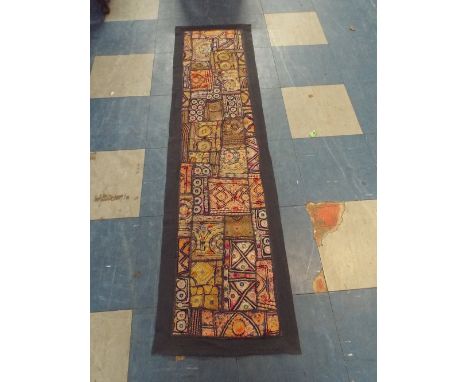 An Indian Embroidered and Mirrored Fabric Panel with Geometric Design, 145cm x 32cm 