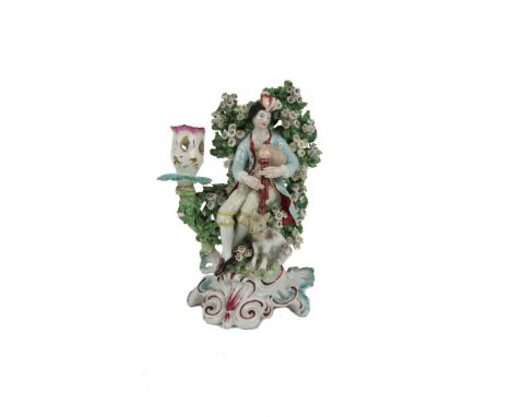 An early Derby flower encrusted porcelain Candlestick, of a Piper and a Dog, approx. 19cms. (1)&nbsp;Provenance:&nbsp;The McD