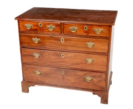 A Georgian mahogany Chest, with plain moulded top over two short and three long graduating drawers with ornate brass drop han