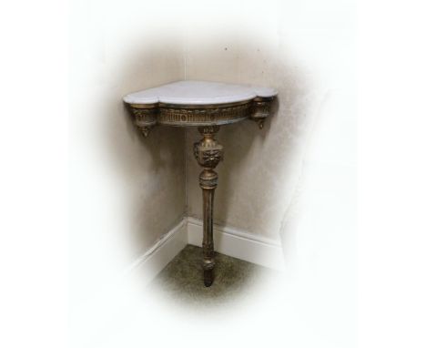 A pair of 19th Century English giltwood Corner Console Tables, each with moulded shaped white marble top above a moulded frie