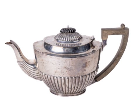 A large English Georgian style silver Teapot, with reeded hinged domed lid and similarly decorated body, with ebonised finial