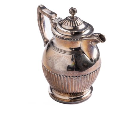 A quality Irish silver Georgian period Hot Water Jug, the domed hinged lid with pomegranate finial, the edge with egg n' dart